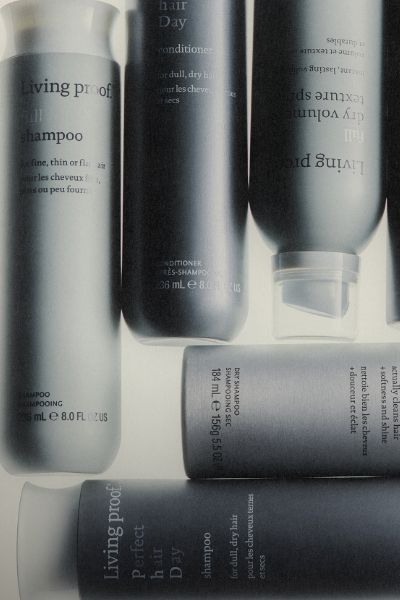 Collection of haircare products from Living Proof on a white background